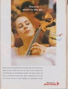 Poster advertising Austrian Airlines in magazine from 1992, There is music in the air slogan Royalty Free Stock Photo