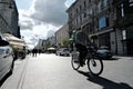 09/20/2019 Lodz, Poland. Delivery man riding a bicycle on Piotrkowska Street Royalty Free Stock Photo