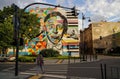 Lodz, Poland: A girl crossing a zebra cross against a picture painted as a street art of the colorful Artur