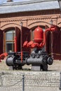 Old red water pump in front of Fire station in the area Ksiezy Mlyn former textile factory, Lodz, Poland Royalty Free Stock Photo
