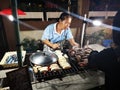 LOEI - JANUARY 13: Unidentified woman selling grilled banana in Chiang Khan night street market on January 13, 2019 in Loei, Royalty Free Stock Photo