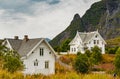 Lofoten Islands, classic norwegian landscape, small houses of white color on the coast, rocky coast with dramatic sky