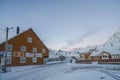 Lofoten Islands - December 2 2018: Yellow traditional houses covered with snow in winter