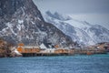 Lofoten Islands, dramatic landscape at sunset. dark clouds over the fishing village, boats and mountain peaks Royalty Free Stock Photo