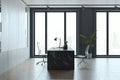 Loft concrete and wooden office interior with furniture and daylight, window and city view. Royalty Free Stock Photo