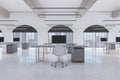 Loft coworking office interior with empty computer screens on desks, concrete flooring and window with city view. Workplace Royalty Free Stock Photo