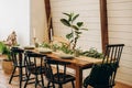 The loft dining table is decorated with flowers, candles and herbs. Soft selective focus