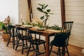 The loft dining table is decorated with flowers, candles and herbs. Soft selective focus