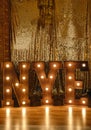 Loft idea for Christmas. Bulb lights on wooden stand letters NYE Royalty Free Stock Photo