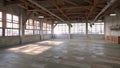 A loft with an industrial aesthetic featuring exposed beams and pipes and an unobstructed view of the entire floor