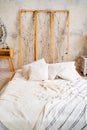 Loft interior. a bed with an unusual headboard. make-up table with a mirror Royalty Free Stock Photo