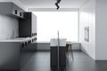 Gray loft kitchen with a bar, side view Royalty Free Stock Photo