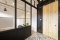 Loft-style apartment for vacation rental with a French-style black metal partition, a sliding wooden door leading to a pantry, and Royalty Free Stock Photo