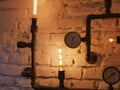 Loft style decor With iron pipes. and incandescent lamps. Loft style wall and steampunk pipes Royalty Free Stock Photo