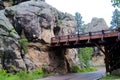 Log Bridge to Entrance of Tunnel Thru the Rock Royalty Free Stock Photo