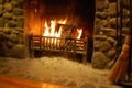 Log burning in stone fireplace