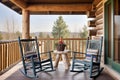 log cabin balcony with wooden rocking chairs and table Royalty Free Stock Photo