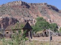 Log cabin and a barn house at the foot of a hill at Grafton ghost town, Utah Royalty Free Stock Photo