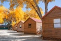 Log cabin in campground with autumn tree. Royalty Free Stock Photo