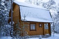 a log cabin covered in snow in the middle of a snowy forest Royalty Free Stock Photo