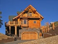 Log Cabin Home Exterior with Warm Fireplace ~ Perfect Vacation Royalty Free Stock Photo