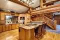 Log cabin kitchen interior design with honey color cabinets. Royalty Free Stock Photo