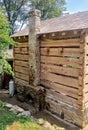 Log cabin natural stone fireplace and chimney chinking with mortar Royalty Free Stock Photo