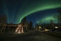 A log cabin in pine forest under Aurora borealis at YellowKnife Royalty Free Stock Photo