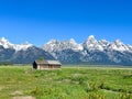 A log cabin with the Teton Mountain Range behind in Grand Teton National Park near Jackson Hole, Wyoming Royalty Free Stock Photo