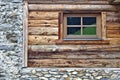 Log cabin wall with window and field stone foundation