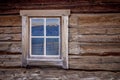 Log cabin window with mountain reflection