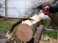 Log with peeled bark on blurred background forester with ax Royalty Free Stock Photo