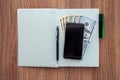 The daily log with denomination dollars on a wooden table. Royalty Free Stock Photo