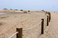 Log fence in a sandy shore on a sunny morning Royalty Free Stock Photo