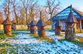 The log hives on the snowy lawn, Polissya region, Pyrohiv Skansen, Kyiv, Ukraine