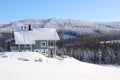 Log house in the snow in the sunhine