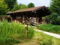 Log house surrounded by beatuiful green garden Royalty Free Stock Photo