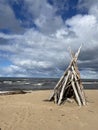 a log hut on the sand beach against the backdrop of the sea driftwood hut Royalty Free Stock Photo