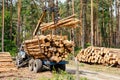Log loader or forestry machine loading its body Royalty Free Stock Photo