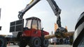 Log loader or forestry machine moves fresh cut logs for loading