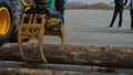 Log loader or forestry machine moves fresh cut logs for loading