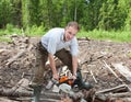 Log processing by a petrolsaw Royalty Free Stock Photo