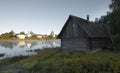 Log wooden house on background Fortress in the city of Staraya Ladoga on the Volkhov River with a foggy psummer dawn, Royalty Free Stock Photo