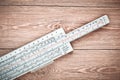 Logarithmic ruler on a wooden table. Stationery for engineers and students