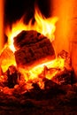 Logfire in brick stove fireplace. Abstract fire frame with swirling red, orange, and yellow flames Royalty Free Stock Photo