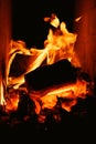Logfire in brick stove fireplace. Abstract fire frame with swirling red, orange, and yellow flames
