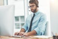 Logged in to listen. Shot of a young man working in a call center. Royalty Free Stock Photo