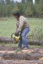 A logger cutting a log