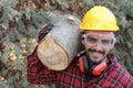 Logger holding heavy trunk in the forest Royalty Free Stock Photo