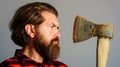 Logger tool. Bearded man in plaid shirt with axe. Canadian lumberjack with hatchet. Closeup portrait. Royalty Free Stock Photo